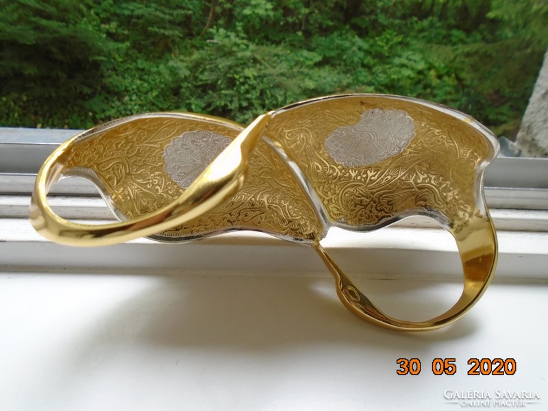 Handmade table centerpiece with a pair of gilded plastic swans, detailed relief patterns