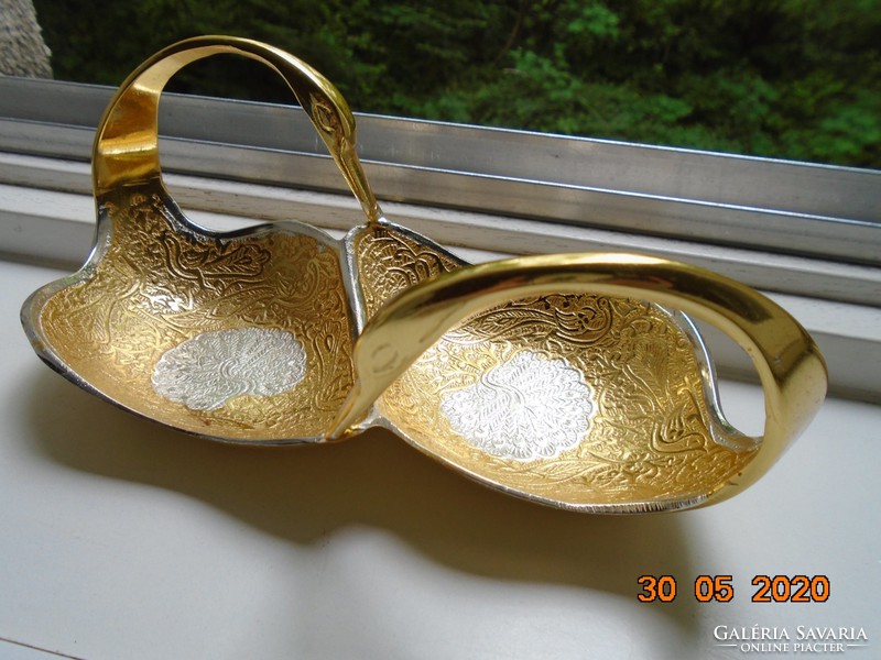 Handmade table centerpiece with a pair of gilded plastic swans, detailed relief patterns