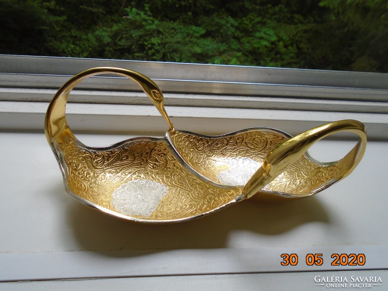 Handmade table centerpiece with a pair of gilded plastic swans, detailed relief patterns