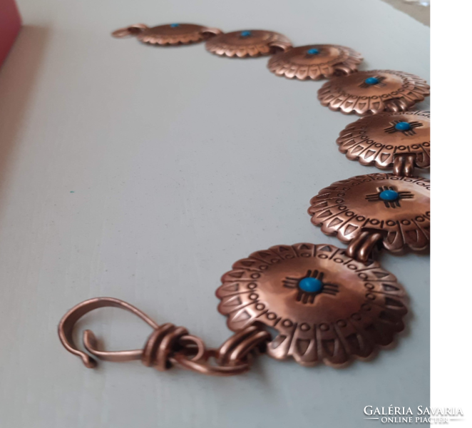 Old custom bronze handmade bracelet adorned with tiny blue spherical stones