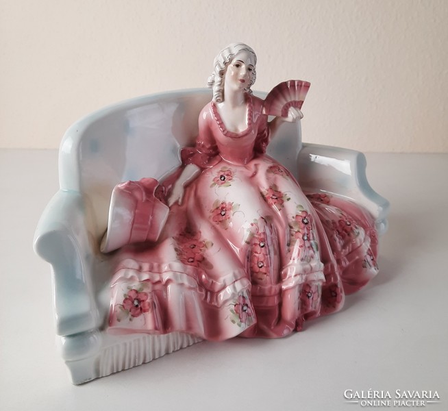 Art deco lady sitting on sofa, ceramic statue