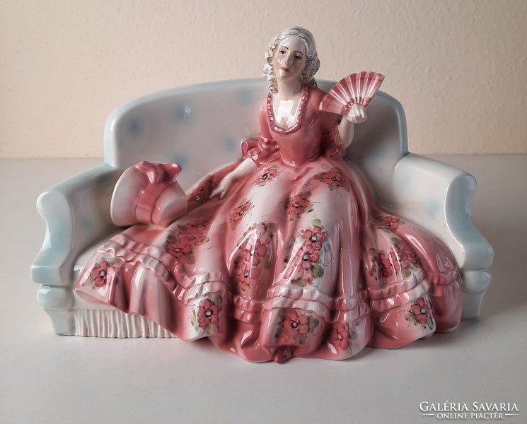 Art deco lady sitting on sofa, ceramic statue