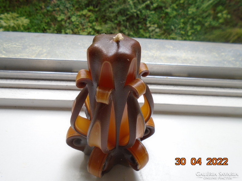 Artistic candle in flower shape with amber and brown color