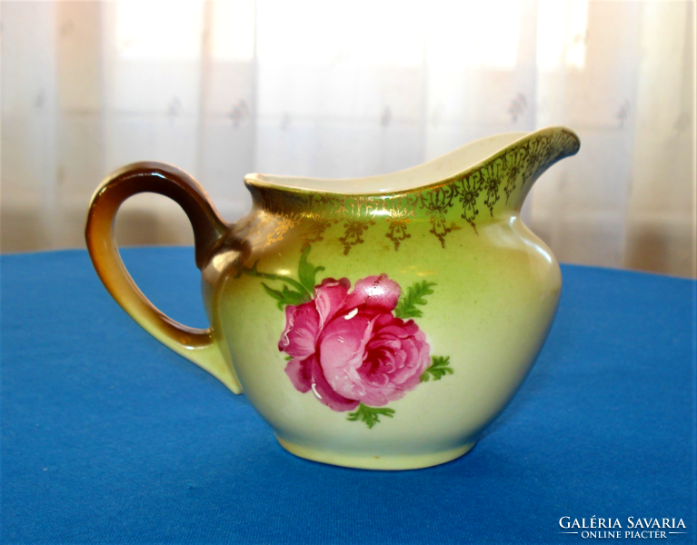 Antique rose patterned teapot, tea serving and milk, cream or lemon pouring jug