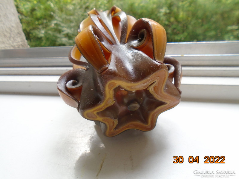 Artistic candle in flower shape with amber and brown color