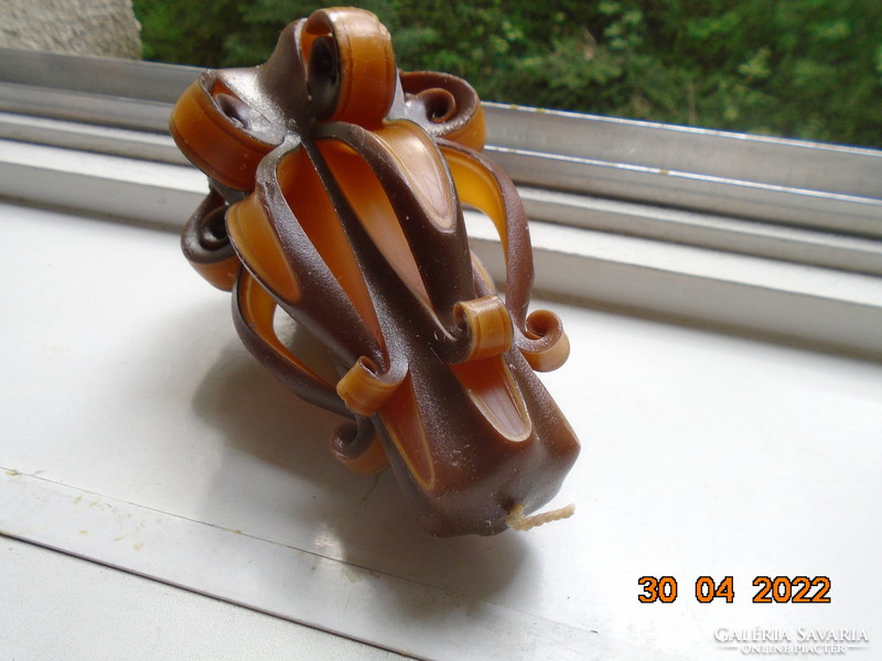 Artistic candle in flower shape with amber and brown color