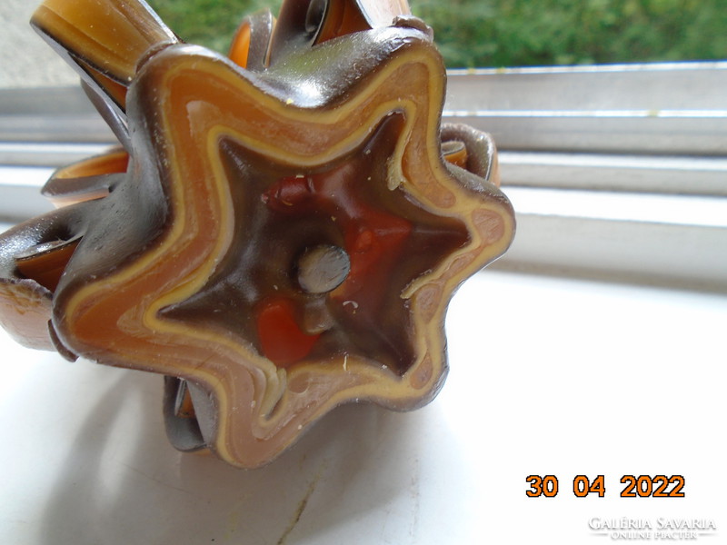 Artistic candle in flower shape with amber and brown color