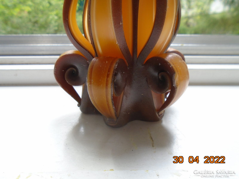 Artistic candle in flower shape with amber and brown color
