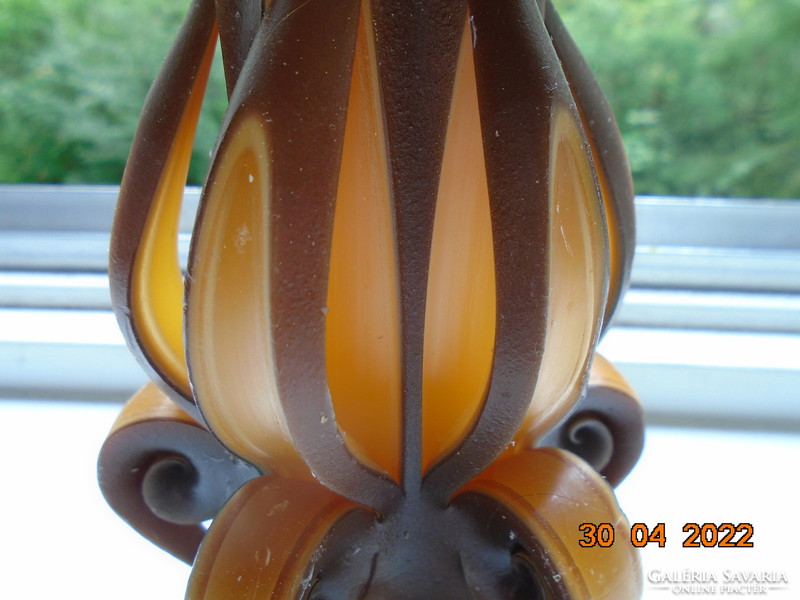 Artistic candle in flower shape with amber and brown color