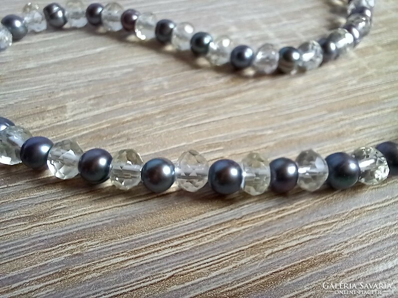 A string of pearls made of cultured pearls and polished rhinestones