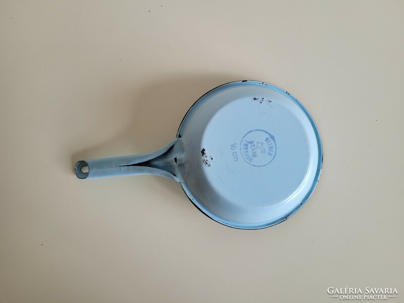 Old vintage blue frying pan with white handle