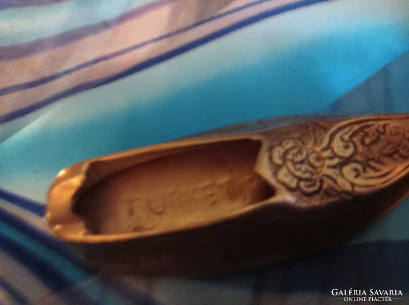 Turkish copper shoes in ashtray