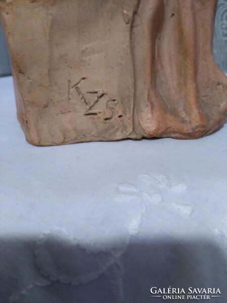 Terracotta statue with K sign