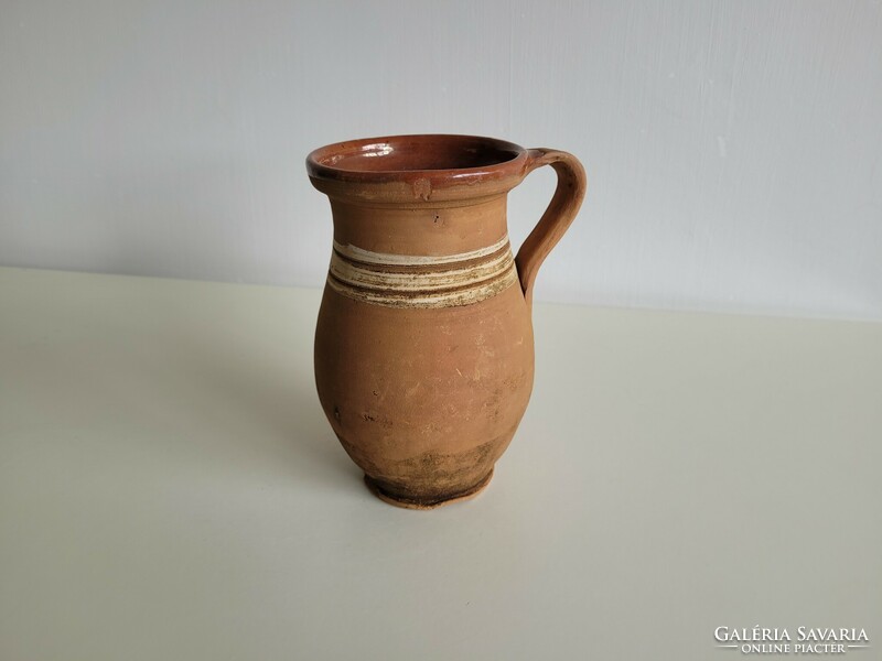Old vintage glazed folk earthenware milk jug pot with handle jug earthenware jug