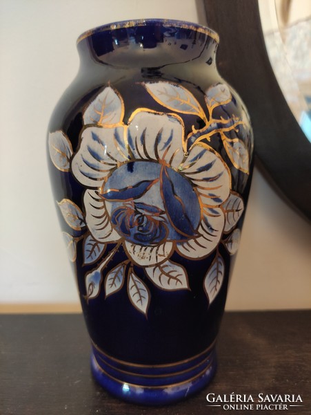 Beautiful antique raven rhyolite porcelain vase with lush floral motif in royal blue with white gold contour