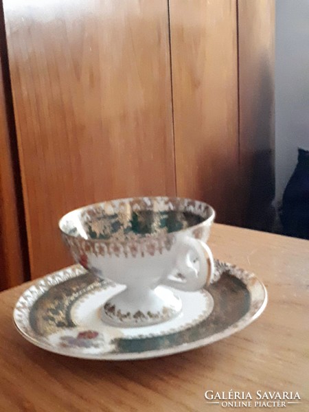 Porcelain coffee cup with saucer on antique altwien