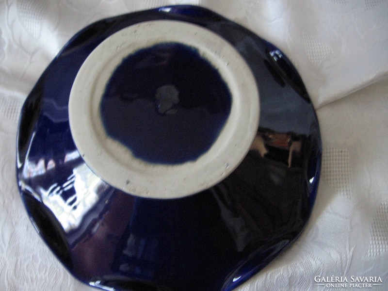 Bowl of wavy fruit with cobalt blue ceramic base