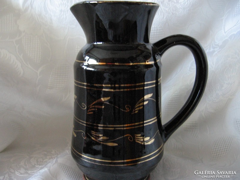 Retro decorative black and gold ceramic jug with vase