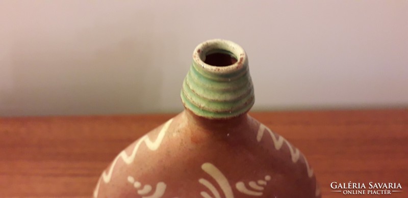 Old ceramic water bottle with folk motif cognac boutique bottle