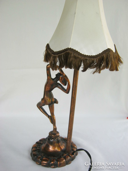 Female nude with metal lamp