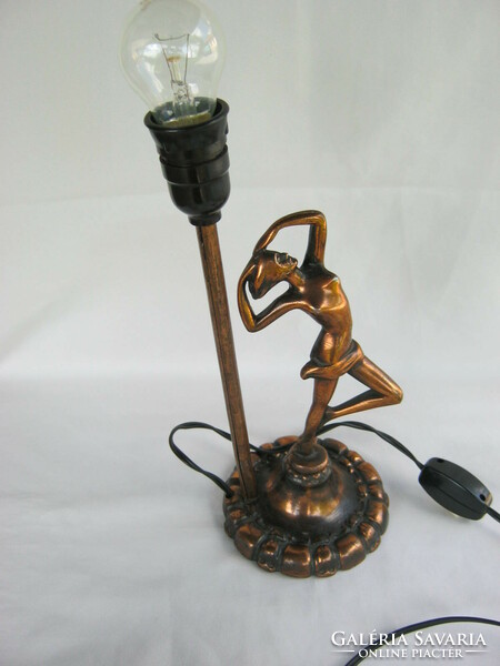 Female nude with metal lamp