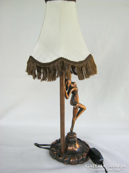 Female nude with metal lamp