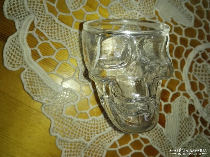 Glass of brandy with skull and crossbones.