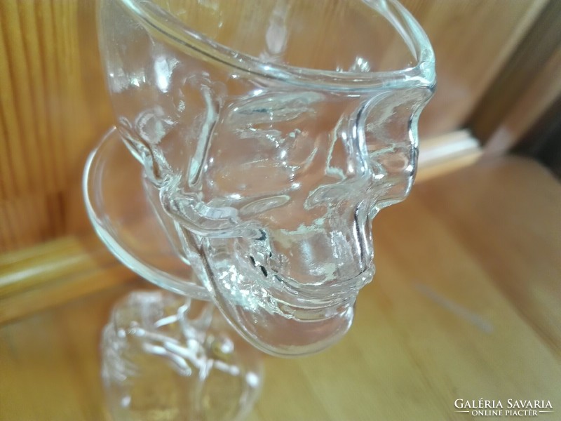 Glass of brandy with skull and crossbones.