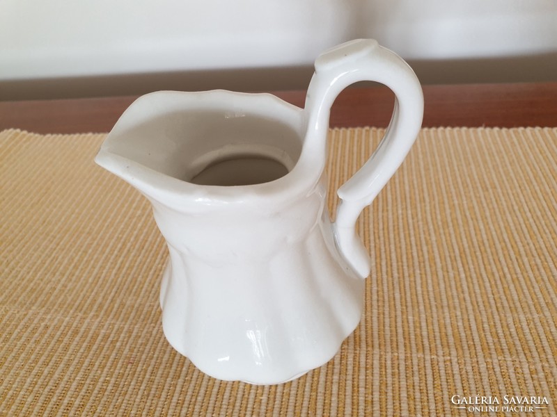 Old small jug with antique porcelain milk spout