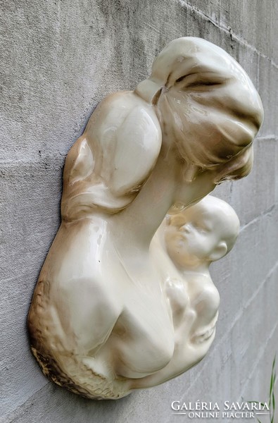 Earthenware wall decoration. Mary with her child.