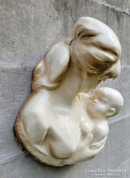 Earthenware wall decoration. Mary with her child.