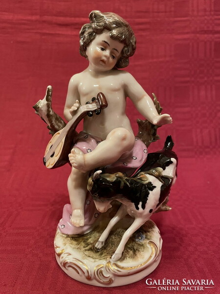 Antique winged angel (cupid) with goat