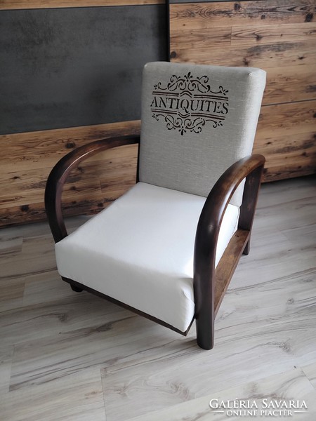 Vintage, slightly rustic armchair with huge wooden armrests