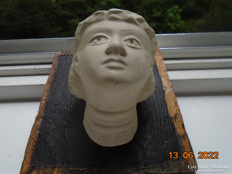 Female plaster head in ancient style with laurel wreath