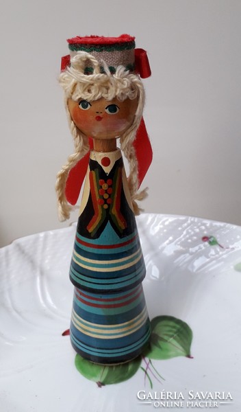 Old Russian wooden girl in traditional costume. Hand painted, wonderful