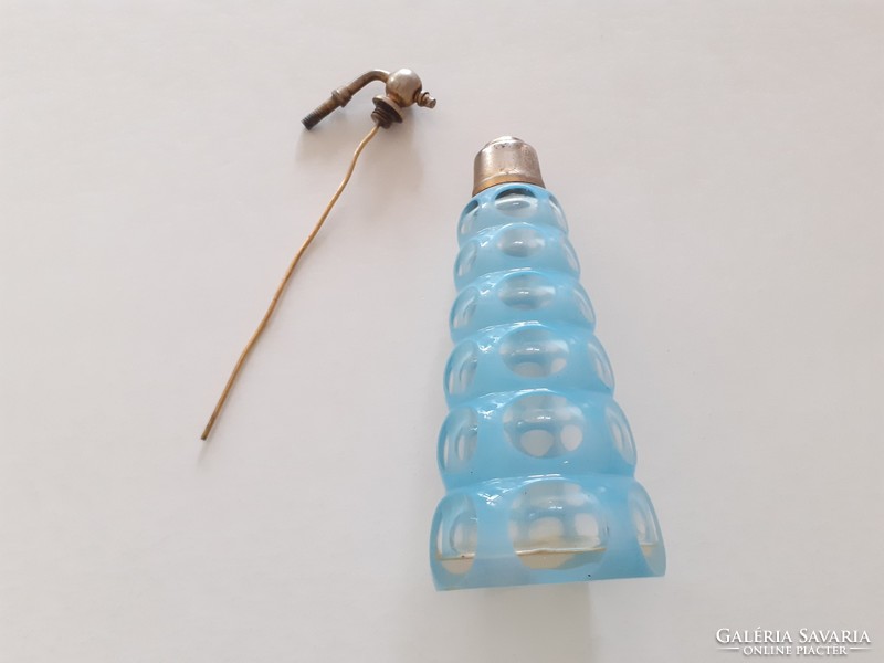 Old art deco perfume bottle with circular 1930s peeled blue polka dot glass cologne