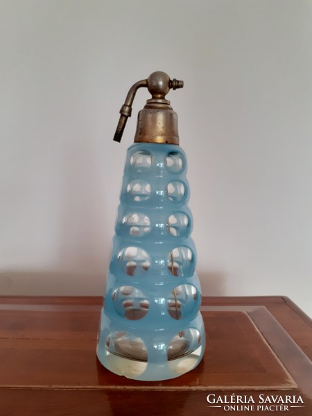 Old art deco perfume bottle with circular 1930s peeled blue polka dot glass cologne