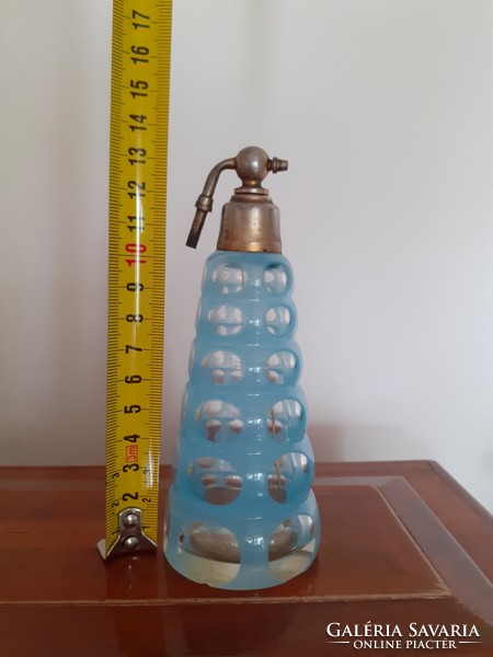 Old art deco perfume bottle with circular 1930s peeled blue polka dot glass cologne