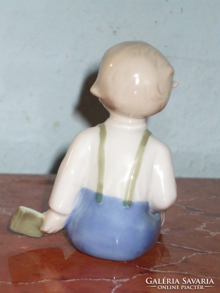 German porcelain little boy with book.