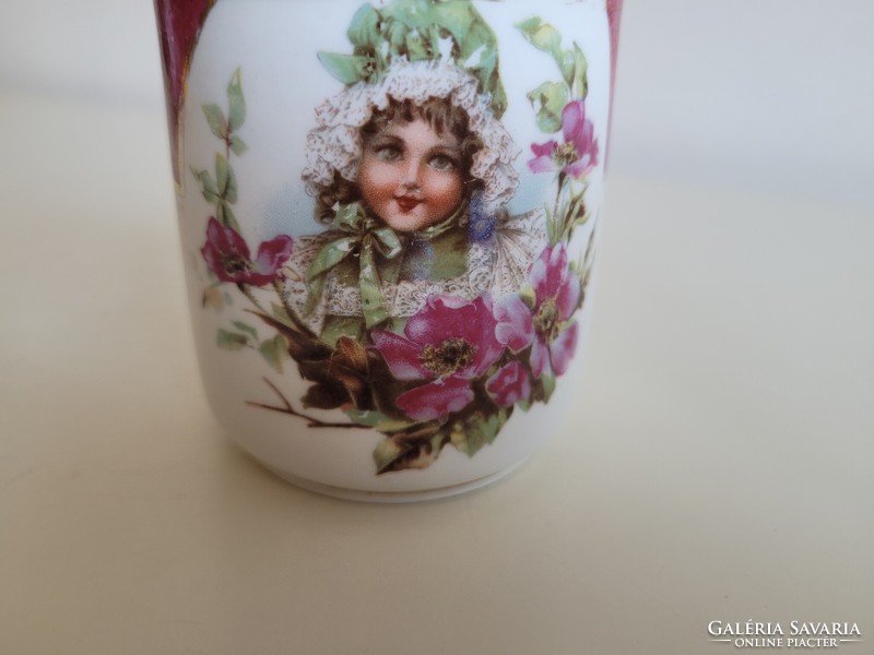 Old porcelain small mug with little girl's floral pattern