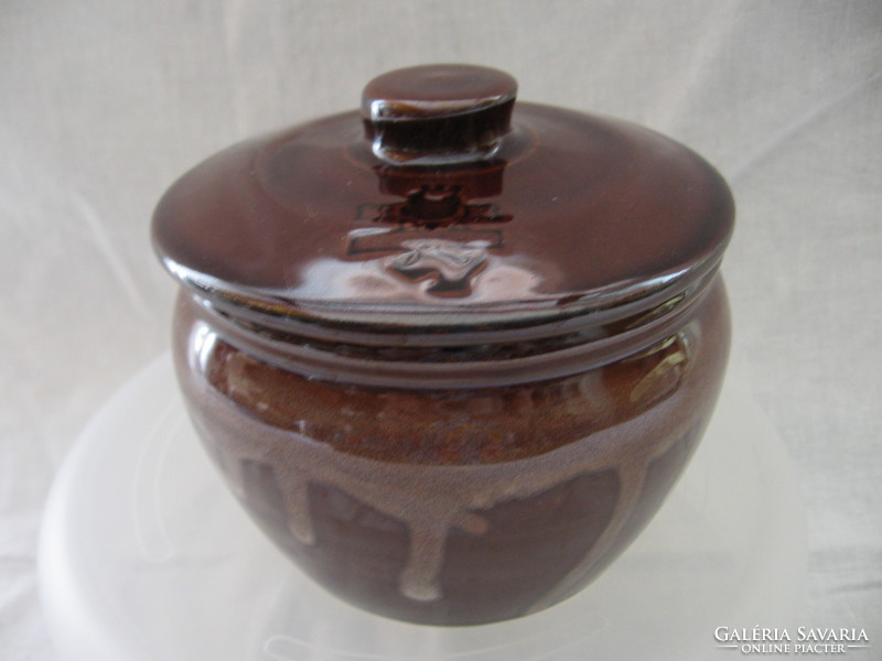 Brown jar with crowned teddy bear