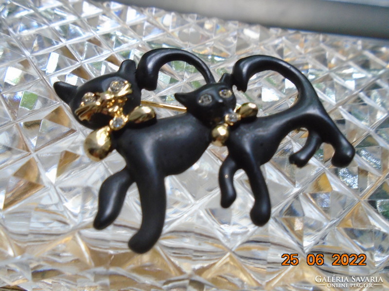 Black cat paired with enameled gilded brooch with polished stone eyes, gilded mustache and bow