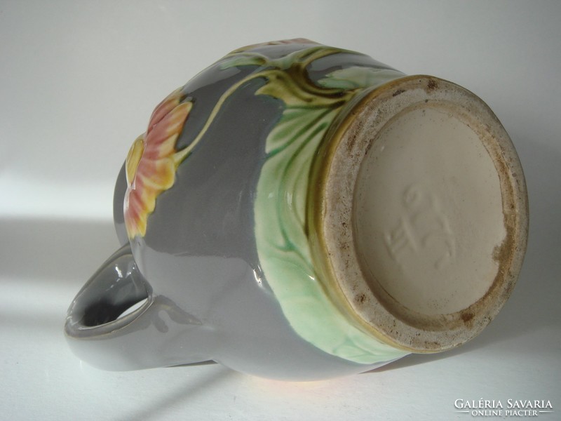 Old majolica jug with floral vintage faience marked with folk spout