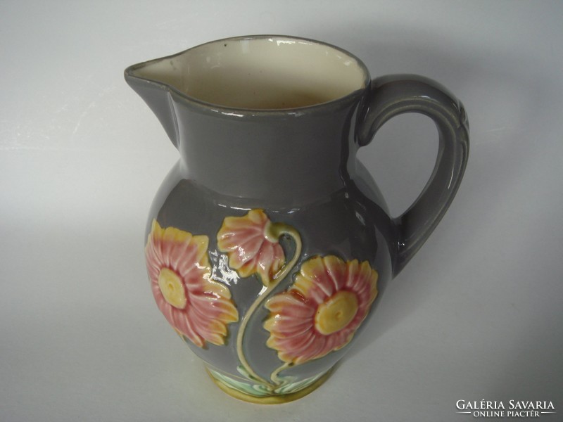 Old majolica jug with floral vintage faience marked with folk spout