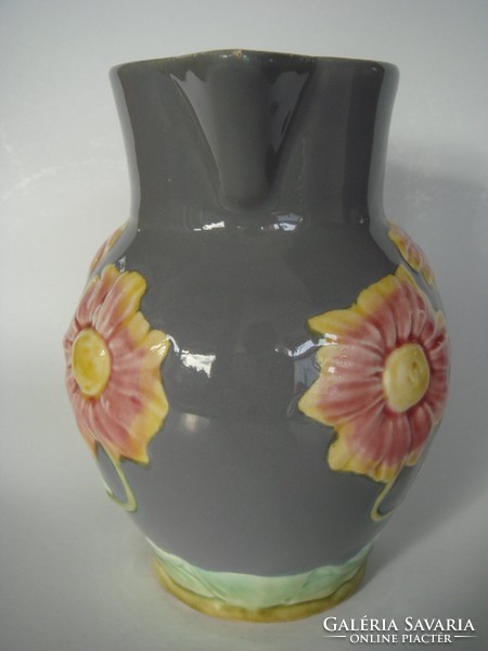 Old majolica jug with floral vintage faience marked with folk spout