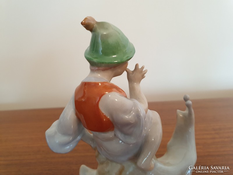 Old drasche porcelain figurine of a boy sitting on a snail