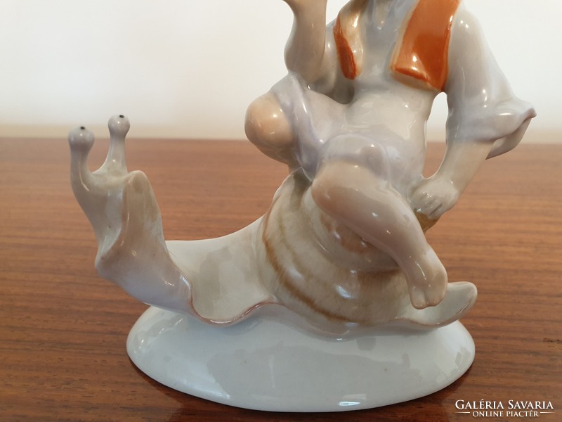 Old drasche porcelain figurine of a boy sitting on a snail