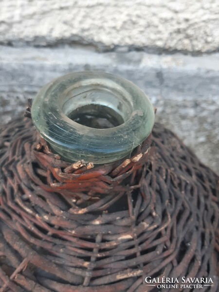 Glass bottle blown into an old shape, in cane braid