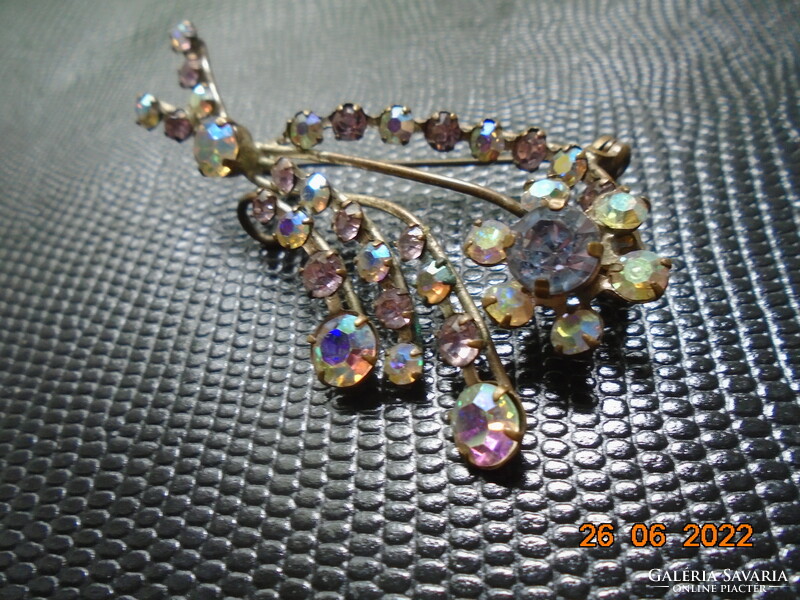 Antique brooch with iridescent polished stones in claw sockets