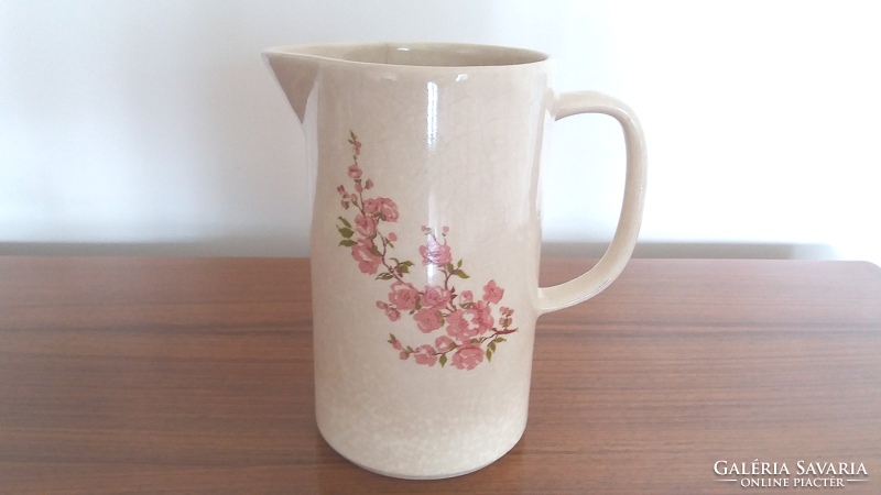 Old ceramic jug with cherry blossom spout